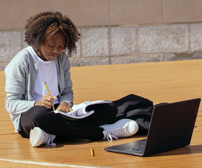 concentrating black girl with laptop